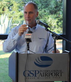 Dave Edwards, President and CEO of the GSP Airport District, offers a toast after announcing that the fixed based operator will be handled in-house under the brand name Cerulean.
 