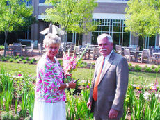 John Mansure, president of Greer Memorial, enjoys the garden and has approved its expansion to add vegetables. 