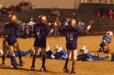 Players in youth leagues are not allowed to rush the kicker on points after touchdown kicks. The kicking team must lay flat on the ground and the defense is allowed to shout, wave their arms and try to distract the kicker.