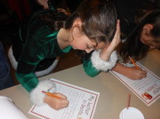 Mary-Kate Marino concentrates on her letter to Santa.