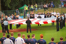 First responders unfurl the United States flag.
 