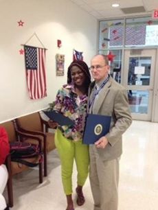 Riverside Principal Andrew Crowley presents Jaquisha Johnson the Certificate of Special Congressional Recognition from House of Representatives Congressman Trey Gowdy.
