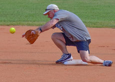 Greer Police Chief Matt Hamby handles this ground ball for a force out at second base.
 