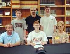Matthew Moore signed to play basketball with North Greenville University. Parents Greg and Tracey Moore flank Matthew. Greer High School coach Jeff Neely stands between Moore's brothers Kyle, right, and Nathan, left.
 
 