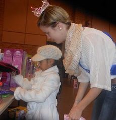 Riley Varner, 2012/2013 Young Miss Teen for Greenwood County, helped children shop during Cops for Tots Saturday at the Cannon Centre.