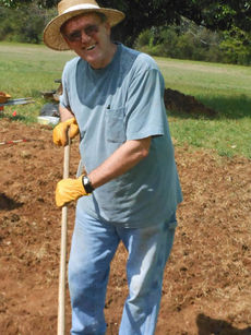 Bobby Reynolds spent the day clearing his plot of debris that remained after the plowing and tilling of the plots.