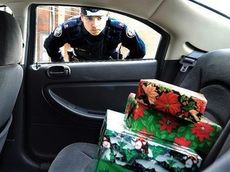 An invitation for thieves: an unlocked vehicle with wrapped presents in the back seat.
 