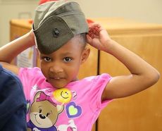 Milani proudly puts on her mother's military cap.
 