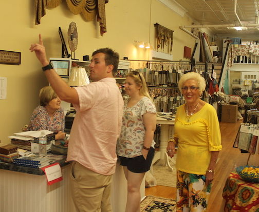 Kim McAbee, and her mother, Nancy, serve customers at the store on Friday,
 
