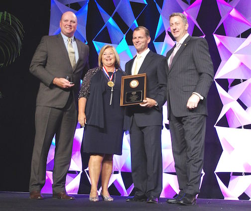 Darla Booher of Greer accepts the National Quality Dealer Award from (left to right) Cox Automotive’s Kevin Filan, NADA Used Car Guide’s Mike Stanton and NIADA executive vice president Steve Jordan at Caesars Palace in Las Vegas.
 
