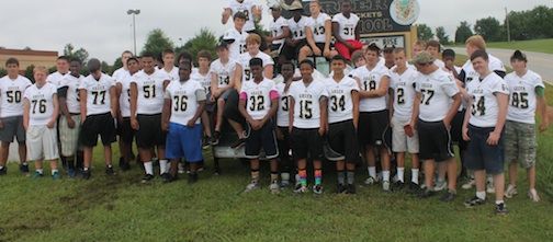 A group photo of the players who picked up trash and other materials that were tossed along the highways.