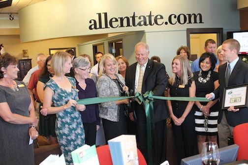 The ribbon cutting ceremony at Allen Tate Realtors Tuesday drew laughter when Allen Smith, President and CEO of the Greer Chamber of Commerce, presented Pat Riley, center, President, of the company, the symbolic framed first $1 proftt.