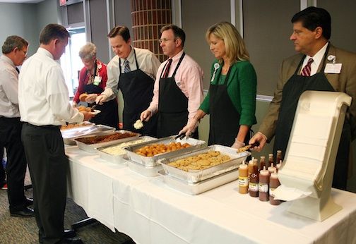Spartanburg Regional Healthcare System executives show their appreciation by serving lunch on Veterans Day to employees who served in the military. The executives, from left, are Mary Jane Jennings, Vice President for System Quality; Harold Moore, Chief Information Officer and Vice President; Phil Feisal, President of Spartanburg Medical Center; Lori Winkles, Vice President of Professional Services; and Anthony Kouskolekas, President of Pelham Medical Center. 
 
 
 
SRHSVeteransDayEvent3
 
Mark Aycock, Chief Operating Officer of Spartanburg Regional Healthcare System, serves cake on Veterans Day to employees who served in the military.
 
 
SRHSVeteransDayEvent5
 
Each veteran received a commemorative Challenge Coin.
 