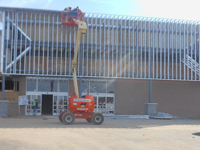 The Walmart Neighborhood Market is beginning to appear like its other brand stores as its facade at Greer Plaza is in its midpoint of completion. A job fair is scheduled Monday, Nov. 26 and the opening is scheduled for February.
