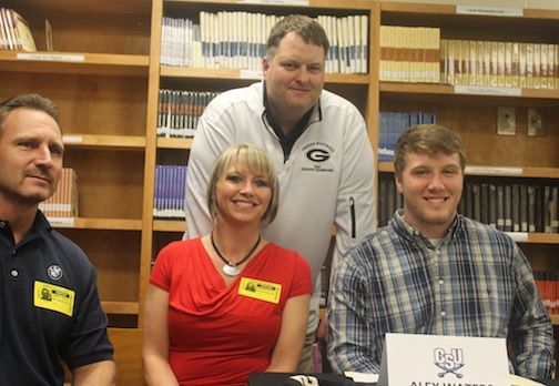 Alex Waters signed a grant-in-aid with Charleston Southern University today. Left to right: Larry Westmoreland, Sebrina Waters Westmoreland and Alex. Greer Head Coach Will Young is behind the family.