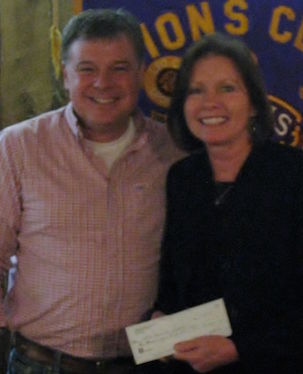 Tony Langford of the Greer Lions Club presents a check for $6,500 to Cindy Simpler, Greer Community Ministries executive director. The money is from the proceeds of the Hot Dog Supper at Big Thursday. Langford is the Big Thursday chair of the Greer Lions Club.
 
 