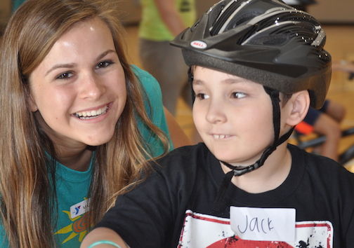  Lindsay Buckles, Development Specialist with the Eastside Family YMCA, gets a smile from a new bike rider.
 
 