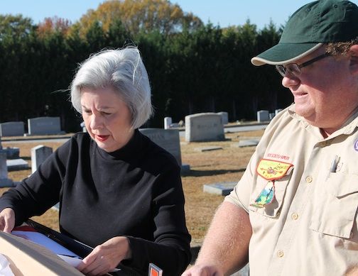 Rose Marie Cooper Jordan and Scoutmaster Mark Green review the cemetery's map.
 