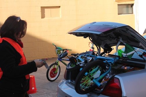 There were strings attached to tie down the trunk lid for the family carrying these bikes home from Greer Relief Thursday.
