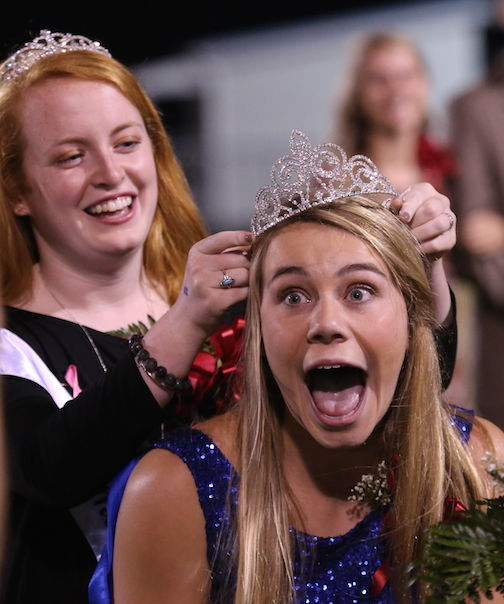 Logan Young is surprised at being named Riverside Homecoming Queen Friday night. Placing the crown is Erin Woods, 2014 homecoming queen.
 