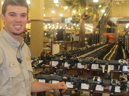 Outfitter Chris Cox stands among 2,900 rods and reels available for sale on April 3. 
 