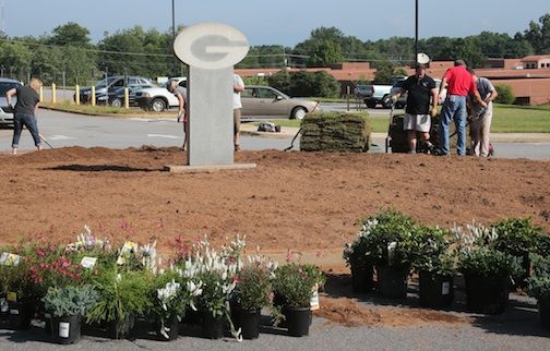 The land was cleared for the planting of bushes, flowers and new grass.