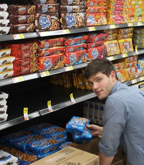 Pierce Putnam, a member of the Nabisco products team, fills the shelves designated for the company's products.