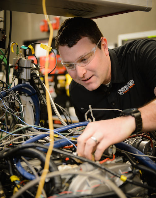 Robert Prucka works on one of the engines at the Clemson University International Center for Automotive Engineering in Greenville.
 