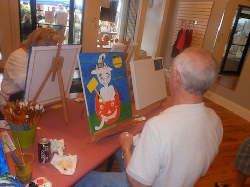 Robert Decker, a local painter, (not show in this photo) was on hand Saturday to guide budding artists drawing a Halloween scene. The Art and Wine Shop was open inviting Oktoberfest visitors inside.