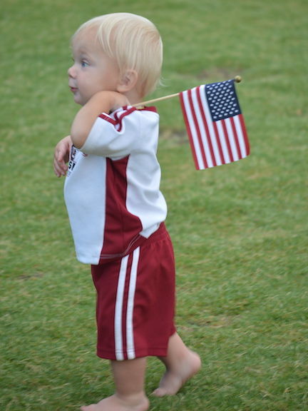 Children waved the American flag with as much gusto as many who honored the veterans and military during the evening.
 