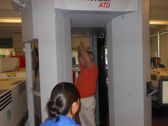 Hands are placed overhead, palms up, for the full body scan. It is reportedly safe for children and pregnant women. Passengers with hip/knee replacements and electronic heart devices are able to pass safely through.