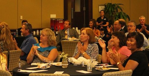 The crowd applauds Smith & James receiving the Mayor's Award at the Small Business dinner Thursday night.
 