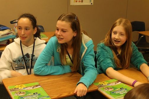 Mrs. Richane Robbins, 7th grade science teacher who assigned the dissection, was on a conference call with the students reminding Emily Patterson, left, Lea Neufeld and Rebecca Dunn of a homework assignment.