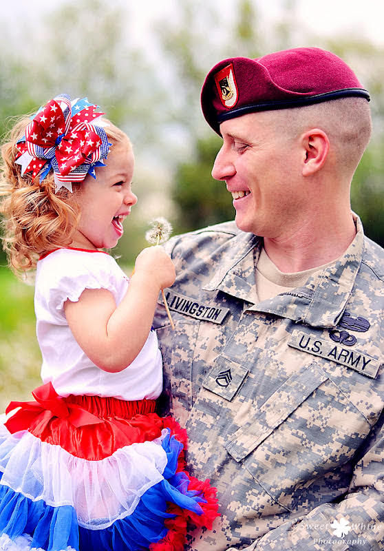 SSG Jason Livingston has a loving armful of Chamberlain, an extremely happy daughter.
 
 