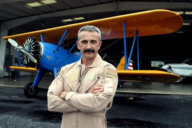 Aaron Tippin proudly stands in front of one of his four planes that are housed in a hangar on his Tennessee estate. Tippin flies frequently, often taking friends and associates to their destinations.
