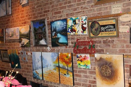 A variety of paintings, produced by local artists, covers one wall in the rear of the coffee shop and wine bar.