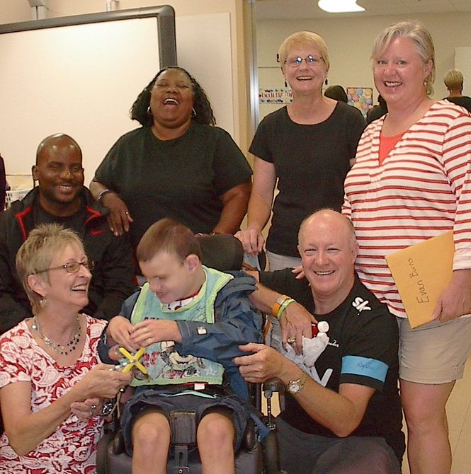 Washington Center student Evan Burns (seated) and family are welcomed to the 2013-14 school year by new teacher, Claire Blouir and staff.