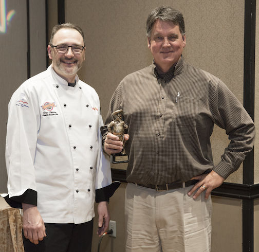 Brian Timmons (right) won the Fudd's Choice award for his winning sandwich of sriracha pimento cheese and bacon burger. Corporate Chef Dan Phalen presents Timmons the award.
 