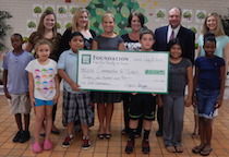 Those in attendance and pictured at the check presentation from left to right, back row, are Emily Shirk, Communities In Schools Site Coordinator at Chandler Creek, Michelle West, Head Teller Poinsett Branch, April Staggs, Vice Chair of the Foundation, Christy Blackwell, Chairman of the Foundation, Chris Talley, COO at Greer State Bank, Amy Clifton Keely, Director of Afterschool Programs, Communities In Schools. Students enrolled in the Communities In Schools Summer Bridge Program are in the front row.
 