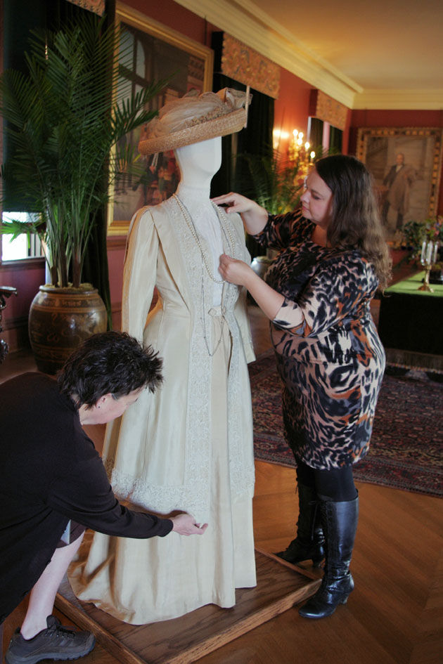Biltmore curator Leslie Klingner, right, and conservator Anne Batram work on a costume now on display in Biltmore House that was worn by actress Dame Maggie Smith's character on Downton Abbey in anticipation of the exhibition, 
