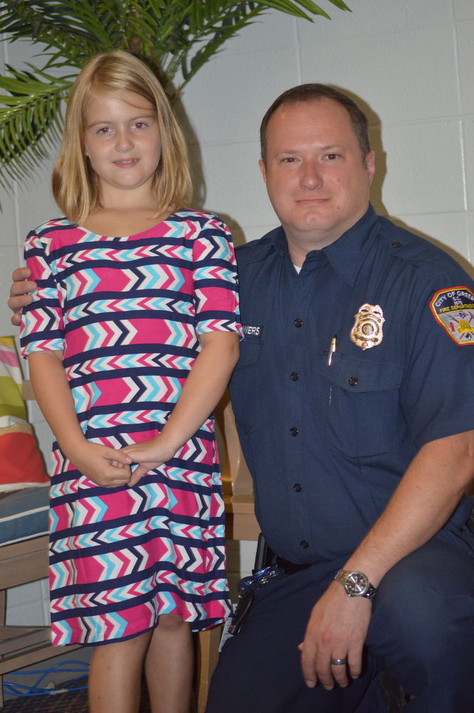 Emma Davis, 7, received an honor from Greer Fire Chief Dorian Flowers at Chandler Creek Elementary Tuesday.
 