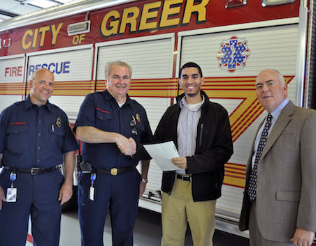 FM Global’s Peter Beshay congratulates Fire Chief Chris Harvey on receiving a fire prevention grant. Fire Marshal Scott Keeley (left) and Greer City Administrator Ed Driggers (right) were also present for the announcement.
 
 