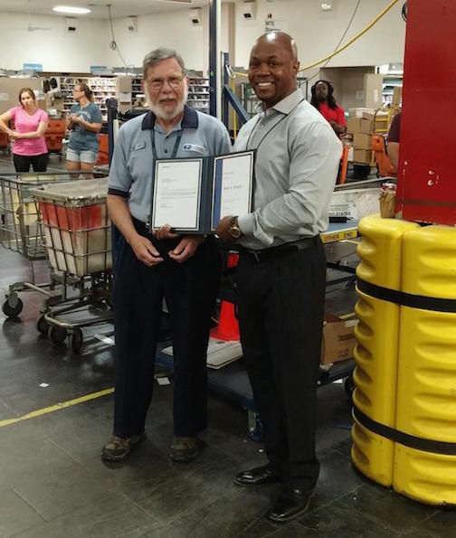 Jim Morgan receives recognition from a USPS supervisor at the Greer Post Office.
 