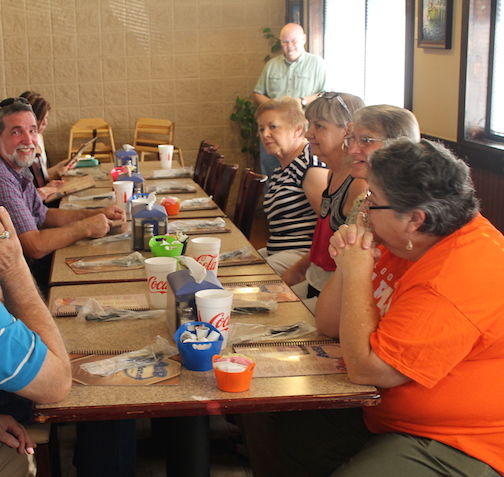 The presentation at a restaurant included family, friends and clients of Larry Beheler's auto sales business.
 