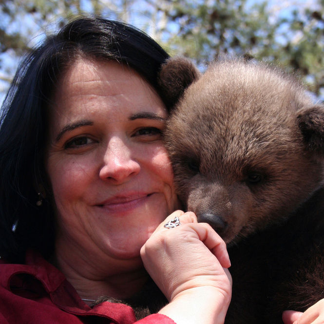 Kim Atchley holds Siri, a rare Syrian brown bear, born at Hollywild.
 
 