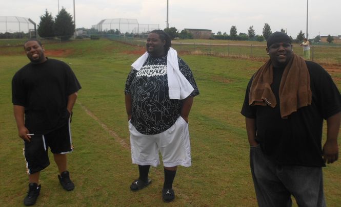 Mario Irby, Jeff Mills (center) and Vic Irby (right) watched the Greer High School spring practice today. The players were all defensive line teammates on the 2003 Greer High School State Championship football team. Mario and Vic were defensive ends and Mills played tackle.