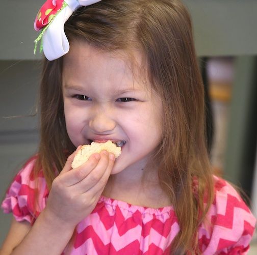 Stella McGinnis takes a bite out a cookie at Krumms on the Plate Thursday at the grand opening of the bakery and catering business.
 