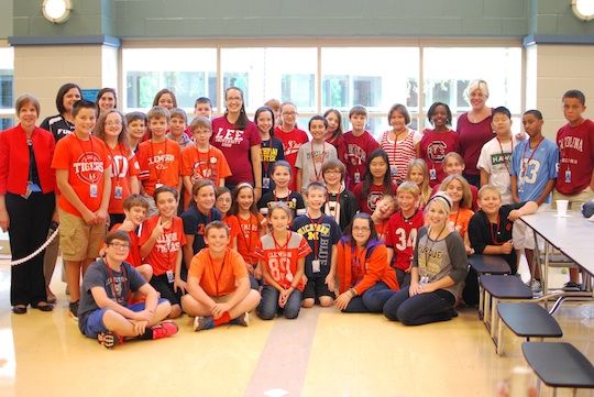 Sixth grade students at Riverside Middle School show their college colors in the photo with principal Kate Malone and 6th grade assistant principal Cindy Bush.
 