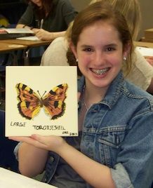Ruth Rogers shows a butterfly created in an Art in History Project based on the Butterflies of Terezin and the Poem, “The Butterfly”.