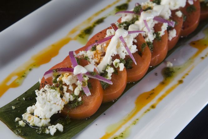 Bruce's plating of this tomato salad exhibits the vibrant colors and tasty appeal of the dish.